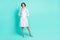 Full length body size photo of nurse smiling wearing white coat glasses looking copyspace isolated vibrant turquoise