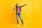 Full length body size photo of schoolgirl listens to music with headphones smiling dancing isolated on bright yellow
