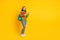Full length body size photo smiling girl in casual clothes keeping book pile backpack isolated vivid yellow color