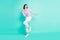 Full length body size photo woman happy overjoyed dancing at party looking copyspace isolated vivid teal color