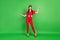 Full length body size photo woman in red outfit smiling comparing blank spaces isolated bright green color background