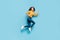 Full length body size profile side view of nice sportive cheerful wavy-haired girl jumping running fast life inspiration