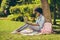 Full length body size side photo of black skinned girl working with laptop education outside in the park wearing glasses