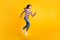 Full length body size side profile photo of running fast happy schoolgirl smiling  on vivid yellow color