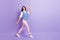 Full length body size view of attractive cheerful friendly girl walking waving you hello greetings  over purple