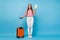 Full length body size view of attractive cheerful girl holding in hands document departure isolated over bright blue