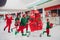 Full length body size view of attractive cheery funky group elfs running buying carrying gifts christmastime eve