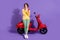 Full length body size view attractive cheery minded pensive girl sitting on bike using gadget creating blog post