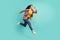 Full length body size view of attractive focused active cheerful girl jumping running isolated over bright teal