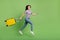 Full length body size view of attractive girl jumping with bag running flight comfort airline isolated on bright green