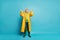 Full length body size view of his he nice cheerful cheery positive glad grey-haired man wearing yellow topcoat expecting