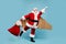 Full length body size view of his he nice fat cheerful purposeful super powerful Santa wearing plane wings flying fast