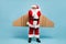 Full length body size view of his he nice fat dissatisfied moody sullen St Nicholas Santa wearing warm coat plane wings