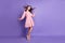 Full length body size view of lovely chic cheery girl dancing posing wind blowing hair isolated over bright violet color
