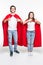 Full length body size view of man and woman in red hero look hugging showing thumbup isolated on white background