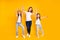 Full length body size view portrait of three nice cute attractive stylish healthy slim cheerful people holding raising