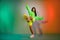 Full length body size view of pretty funky cheerful girl dancing good mood isolated over multicolor vivid neon light