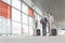 Full length of businesspeople with luggage talking on railroad platform