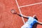 Full length of disappointed mature man lying by tennis racket on court during summer