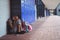 Full length of elementary schoolgirl resting by lockers