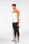Full-length focused, motivated handsome sportsman in activewear, shorts, t-short and sports leggings, stand on