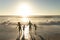 Full length of happy african american enjoying summer sunset at beach against sky