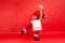 Full length happy satisfied santa claus holding paper bags, doing holidays shopping, enjoying christmas sale