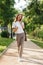 Full length image of caucasian modern woman walking down narrow