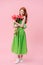 Full length image ginger woman holding bouquet of flowers