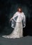 full length of joyful middle aged bride in white wedding dress