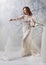 full length of joyful middle aged bride in white wedding dress