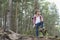 Full length of male backpacker standing in forest