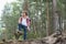 Full length of male backpacker standing in forest