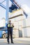 Full-length of male supervisor writing on clipboard in shipping yard