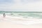 Full length of multiracial mother and children enjoying sunny weekend on shore at beach