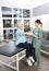 Full Length Of Nurse Putting Crepe Bandage On Patient\'s Hand