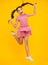 Full length overjoyed teenager kid girl 12 13 14 year jumping old isolated on yellow background studio. Funny jump