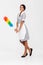 Full length photo of attractive housekeeper posing with colorful