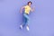 Full length photo of carefree overjoyed person jump rush fast isolated on violet color background