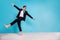 Full length photo of carefree positive guy dressed black tuxedo having fun beach empty space isolated blue color