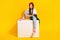 Full length photo of charming little girl sit podium white cube banner dressed stylish white garment  on yellow