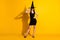 Full length photo of charming lovely mysterious young lady hands hips hold cap smiling fall theme gothic style event