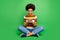 Full length photo cheerful afro american girl sit legs folded use smart phone read social network news comment follow