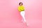 Full length photo of cheerful cute girl dressed neon sweater arms crossed looking empty space isolated pink color