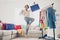 Full length photo cheerful excited woman hold bags stand living room wardrobe buy indoors inside house