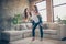 Full length photo of cheerful girls siblings laughing piggybacking wearing white t-shirt denom jeans standing in big