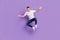 Full length photo of cheerful young happy man jump up funny funky mood active isolated on violet color background