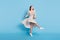 Full length photo of cool brown hairdo young lady dance wear dress isolated on blue background