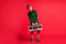 Full length photo cool elf hold boom box x-mas christmas party wear green costume isolated on red shine color background