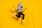 Full length photo of crazy weird guy rocker in zebra mask jump up sing mic isolated over shine yellow color background